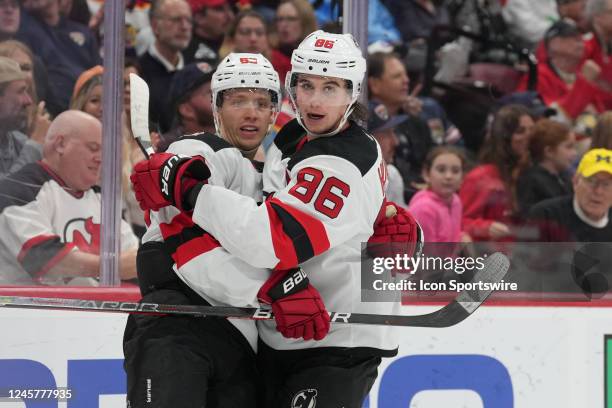 New Jersey Devils left wing Jesper Bratt and New Jersey Devils center Jack Hughes celebrate a goal in the third period during the game between the...