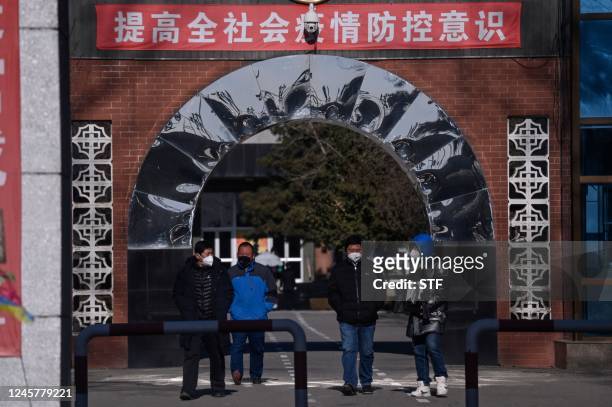 Man holds a framed picture of a loved one at a crematorium in Beijing on December 22, 2022. - Hospitals are struggling, pharmacy shelves have been...