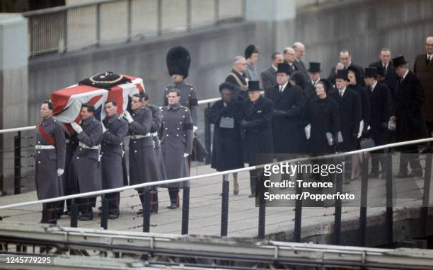 The family follow the Union Jack-draped coffin of former British Prime Minister Winston Churchill carried by military pallbearers during his State...