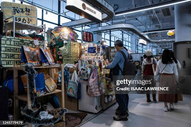 People look at a gift shop in Hong Kong on December 22, 2022. - Hong Kong accused the United States of "totally unreasonable" trade practices on...