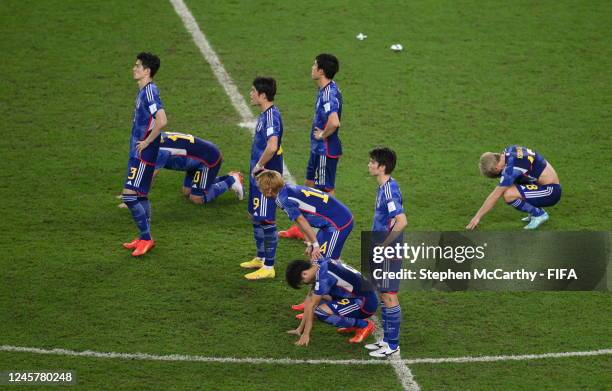 Dejected Japan players following the penalty shoot-out during the FIFA World Cup Qatar 2022 Round of 16 match between Japan and Croatia at Al Janoub...