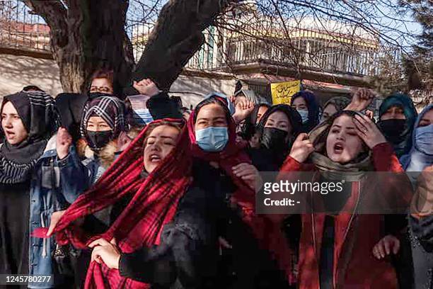 Afghan women chant slogans to protest against the ban on university education for women, in Kabul on December 22, 2022. - A small group of Afghan...