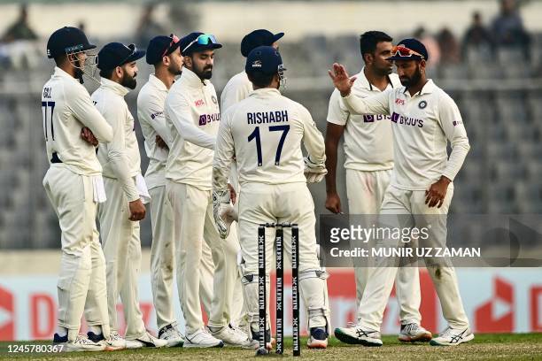Indias cricketers celebrate after the dismissal of the Bangladeshs Mominul Haque during the first day of the second cricket Test match between...