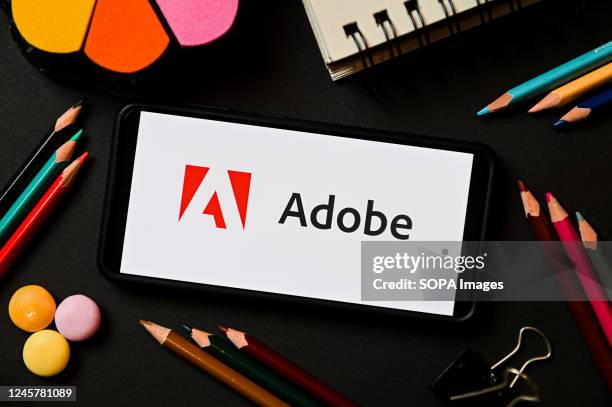 In this photo illustration, an Adobe logo seen displayed on a smartphone.