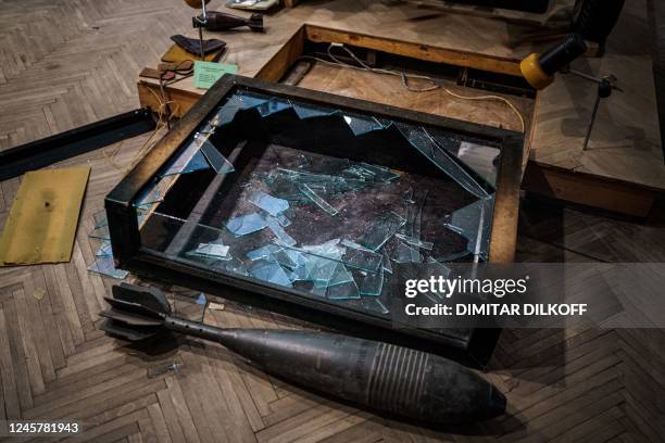 This photograph taken on December 22 shows a broken glass box in the looted museum halls at the Kherson Regional Museum, which specializes in local...