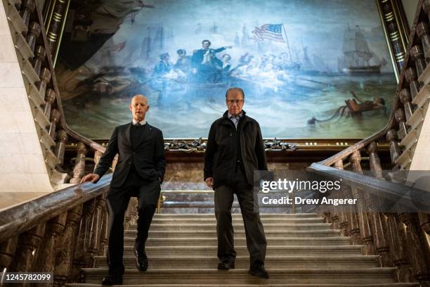 Under the Battle of Lake Erie painting by William Henry Powell, Sen. Rick Scott and Sen. Mike Braun walk toward the Senate floor at the U.S. Capitol...