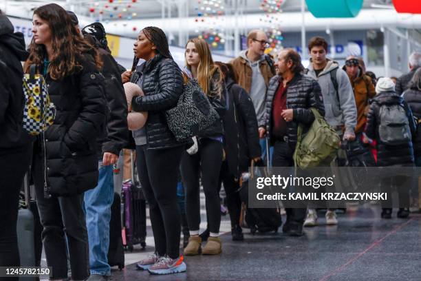 Travelers wait in line to check-in for their flights at the United Airlines Terminal 1 ahead of the Christmas Holiday at O'Hare International Airport...