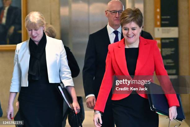 Scotland's First Minister Nicola Sturgeon on the way to First Minister's Questions in the Scottish Parliament accompanied by Social Justice Secretary...