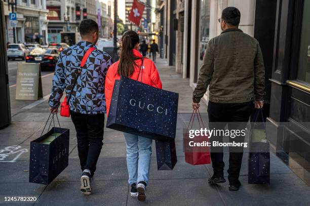 Shoppers carry Gucci bags in San Francisco, California, US, on Wednesday, Dec. 21, 2022. US retail sales fell in November by the most in nearly a...