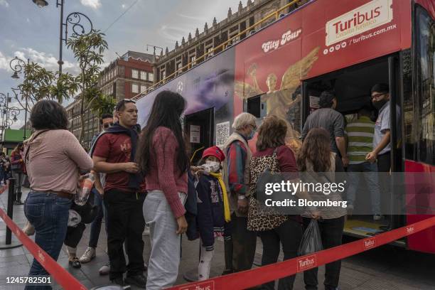 Visitors board a double-decker tour bus in Mexico City, Mexico, on Wednesday, Dec. 21, 2022. The National Institute of Statistics and Geography is...