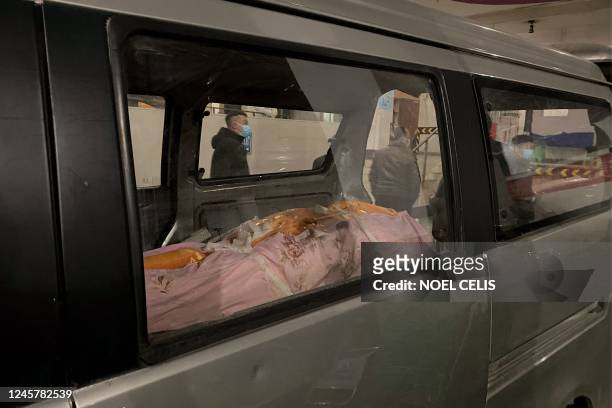 Body is pictured inside a car to be cremated at a crematorium in China's southwestern city of Chongqing on December 22, 2022.