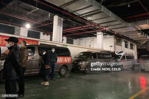 Hearse vans line up carrying each a body to be cremated at a crematorium in China's southwestern city of Chongqing on December 22, 2022.