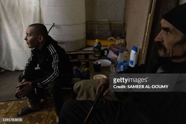 Hleb Petrova sits next to his grandfather in a basement where he takes shelter and live with her family, relatives and neighbours seeking more...