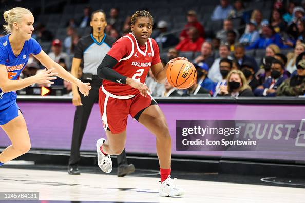 Alberte Rimdal Reyna Scott of the Oklahoma Sooners drives by Alberte Rimdal of the ...