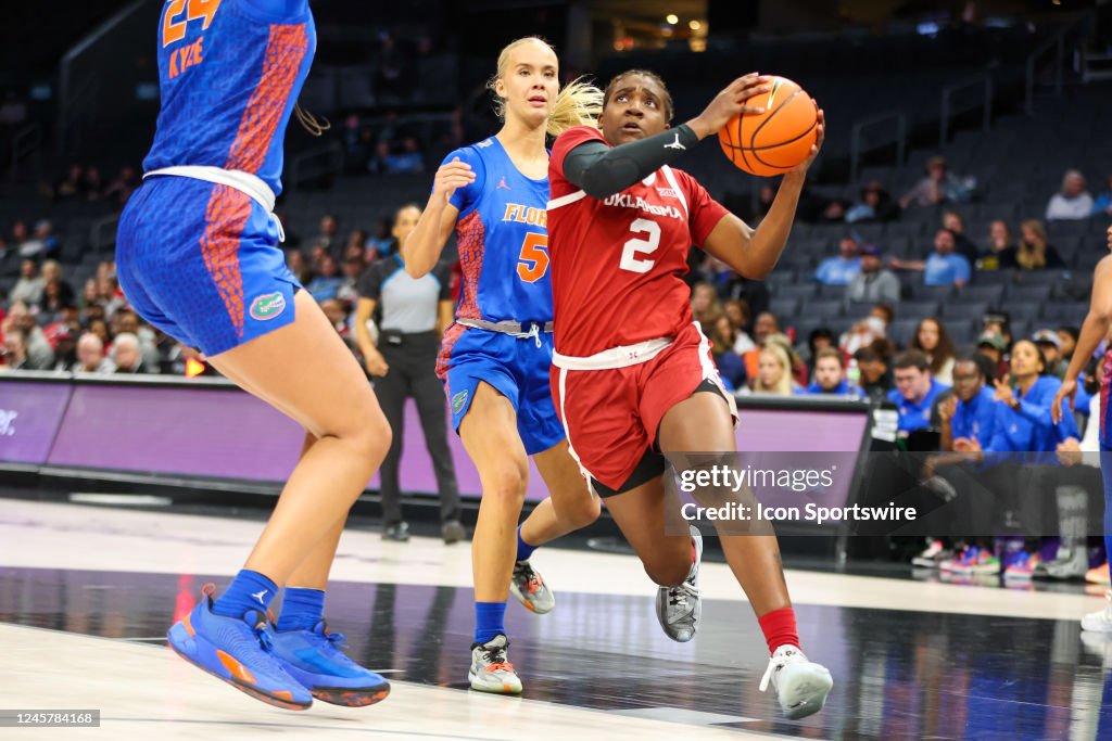 Alberte Rimdal Reyna Scott of the Oklahoma Sooners drives by Alberte Rimdal of the ...
