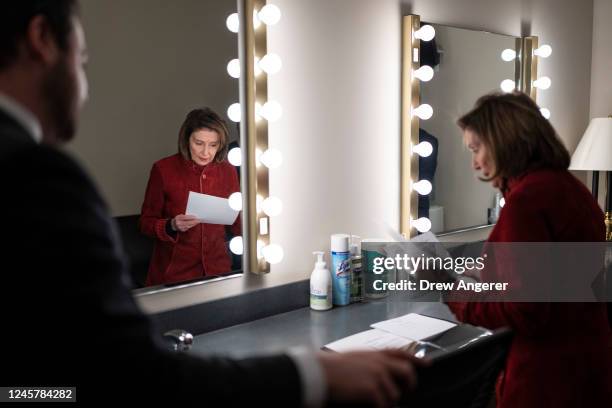 Speaker of the House Nancy Pelosi looks over notes in the green room before the start of her final weekly news conference at the U.S. Capitol on...