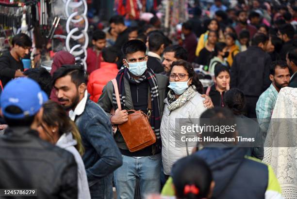 People wear masks as a precautionary measure from COVID at Sarojini Nagar Market on December 22, 2022 in New Delhi, India. Many trader associations...