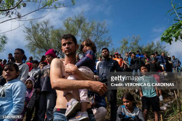 Venezuelan asylum seeker Jehan Carlo Ramirez carries his daughter Joannys S. Ramirez before they cross the Rio Grande into Brownsville, Texas, the...
