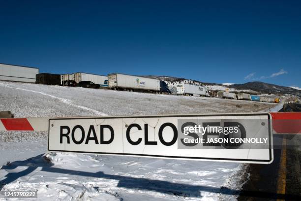 Semitrucks line up in the eastbound land on I-70, which was closed due to extreme winter driving conditons, in Silverthorne, Colorado on December 22,...