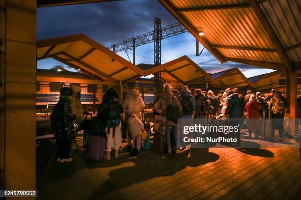 Ukrainians standing in line at passport control after arriving in the evening train from Ukraine to Przemysl railway station. According to research...
