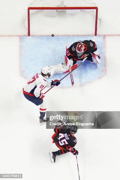 The puck hits the back of the net behind Cam Talbot of the Ottawa Senators after a shot scores from Evgeny Kuznetsov of the Washington Capitals goes...