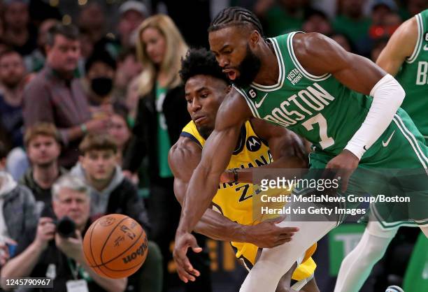 December 21: Aaron Nesmith of the Indiana Pacers and Jaylen Brown of the Boston Celtics go after a loose ball during the second half of the NBA game...