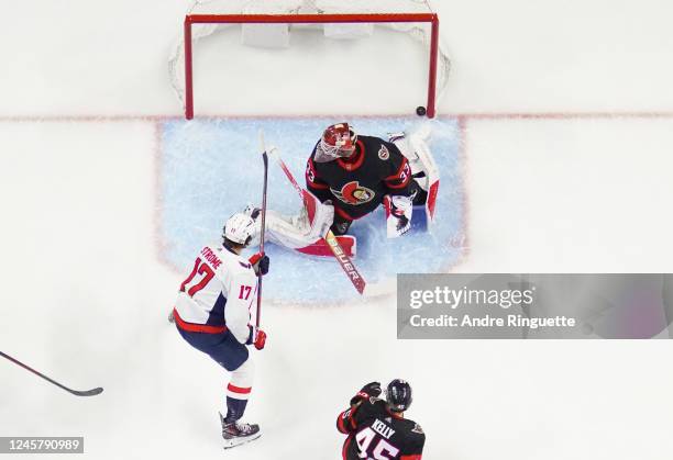 The puck hits the back of the net behind Cam Talbot of the Ottawa Senators after a shot scores from Evgeny Kuznetsov of the Washington Capitals goes...