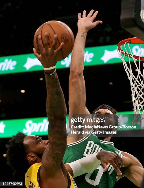 December 21: Jayson Tatum of the Boston Celtics block Oshae Brissett of the Indiana Pacers from scoring during the first quarter of the NBA game at...