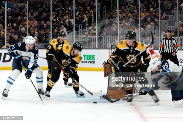 Boston Bruins left defenseman Matt Grzelcyk moves in for the rebound off goalie Jeremy Swayman during a game between the Boston Bruins and the...