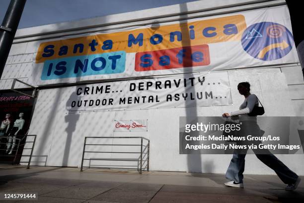 Sign on a vacant storefront along the Third Street Promenade reading "Santa Monica is not safe. Crime ... Depravity ... Outdoor mental asylum,...
