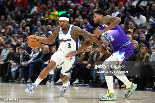 Bradley Beal of the Washington Wizards drives around Rudy Gay of the Utah Jazz during the first half of a game at Vivint Arena on December 22, 2022...