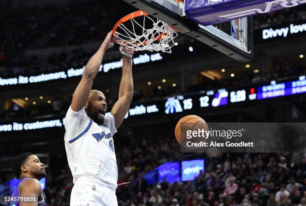 Taj Gibson of the Washington Wizards dunks over Rudy Gay of the Utah Jazz during the first half of a game at Vivint Arena on December 22, 2022 in...