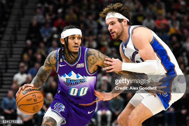 Jordan Clarkson of the Utah Jazz drives into Corey Kispert of the Washington Wizards during the second half of a game at Vivint Arena on December 22,...