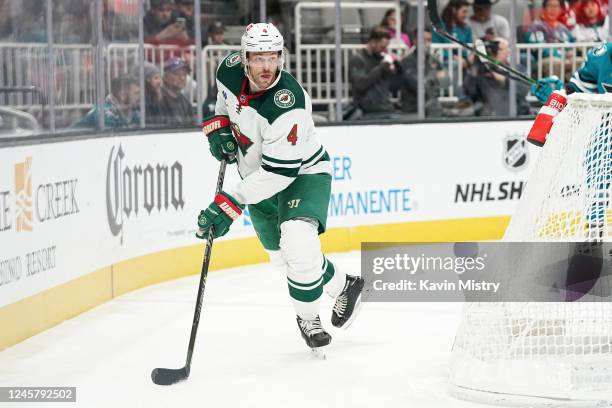 Jon Merrill of the Minnesota Wild skates with the puck against the San Jose Sharks at SAP Center on December 22, 2022 in San Jose, California.