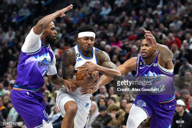 Bradley Beal of the Washington Wizards drives between Mike Conley and Rudy Gay of the Utah Jazz during the first half of a game at Vivint Arena on...