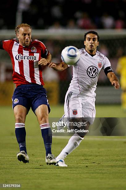 Dwayne De Rosario of D.C. United runs for the ball against Simon Elliott of Chivas USA at The Home Depot Center on September 10, 2011 in Carson,...