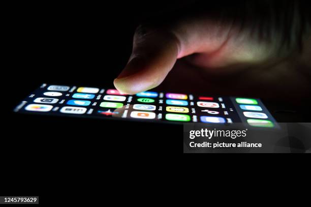 December 2022, Baden-Wuerttemberg, Rottweil: A man holds an iPhone in his hand with application apps on it. Photo: Silas Stein/dpa