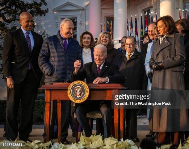 President Joe Biden prepares to sign the Respect for Marriage Act, surrounded by Congressional leaders as he hosts a ceremony on the South Lawn, in...