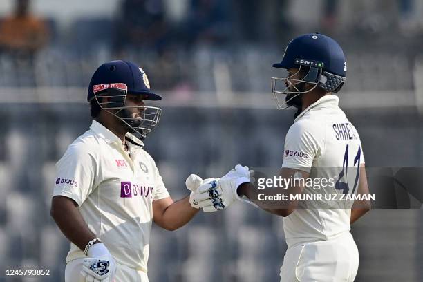India's Shreyas Iyer and Rishabh Pant bump fists during the second day of the second cricket Test match between Bangladesh and India at the...