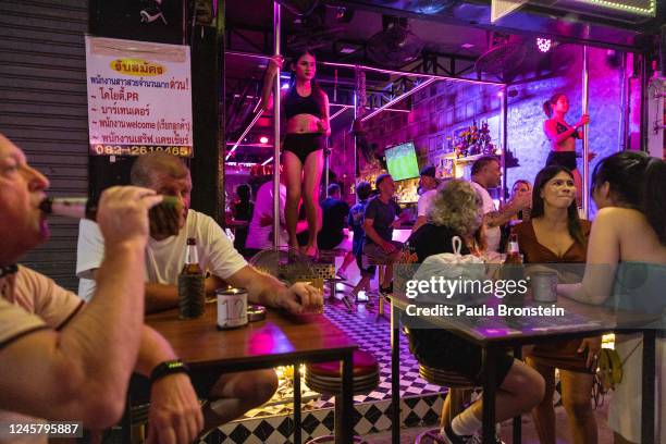 Thai dancers are seen at an outdoor bar on the Patong walking street on December 16, 2022 in Phuket, Thailand. Russians have been flocking to Phuket...