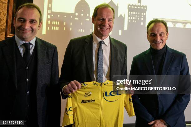 Tour de France General Director Christian Prudhomme holds a yellow jersey and poses with Mayor of Turin Stefano Lorusso , and president of Piedmont...