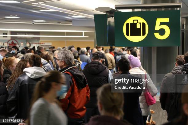 Passengers wait for their bags and luggage at Vancouver International Airport's domestic arrivals on December 22, 2022 in Vancouver, BC, Canada. 115...