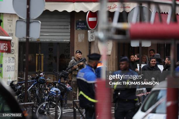 French police and Vigipirat secure the street after several shots were fired along rue d'Enghien in the 10th arrondissement, in Paris on December 23,...