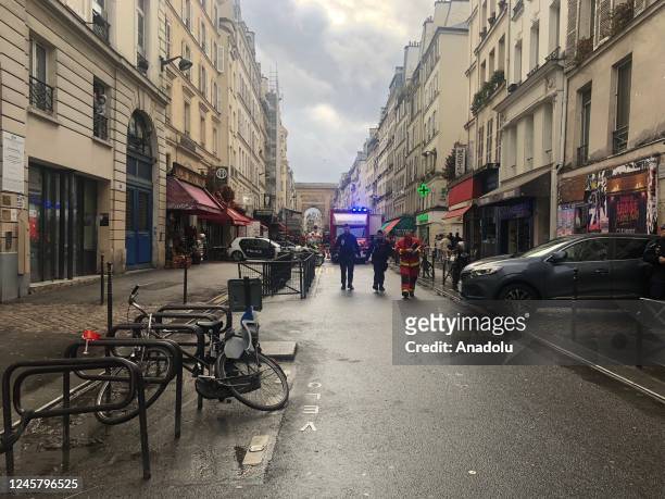 Police take measures in an area after a gunfire left two people dead and four injured in Paris, while a suspect had been arrested, in France on...