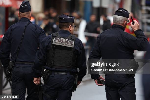 French police secure the street after several shots were fired along rue d'Enghien in the 10th arrondissement, in Paris on December 23, 2022. - Two...