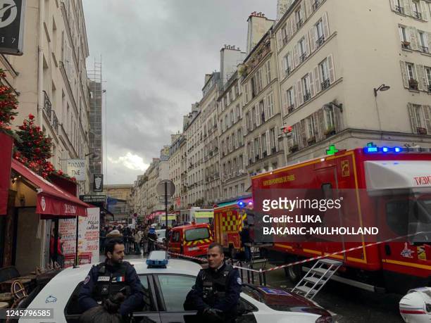 French police and security personnel corden off the area after several shots were fired along rue d'Enghien in the 10th arrondissement, in Paris on...