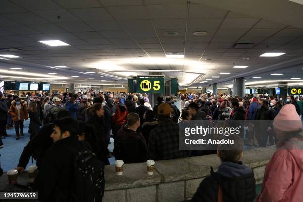 Passengers wait for their bags and luggage at Vancouver International Airport's domestic arrivals after Thursday midnight on December 23, 2022 in...