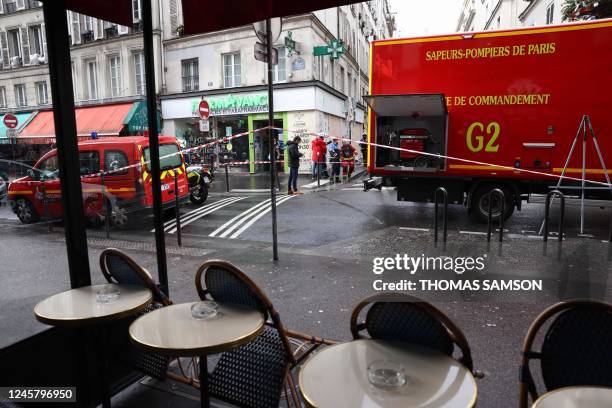 Police tape is used to cordoned off the area following a shooting along rue d'Enghien in the 10th arrondissement, in Paris on December 23, 2022. -...