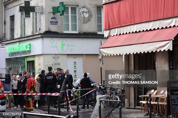 French police secure the street after several shots were fired along rue d'Enghien in the 10th arrondissement, in Paris on December 23, 2022. - Two...