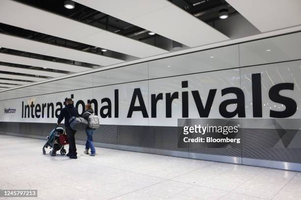 Airline passengers in the arrivals hall at Heathrow Airport in London, UK, on Friday, Dec. 23, 2022. Passengers at UK airports have been threatened...
